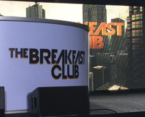 Panel with The breakfast club sign with a backdrop that says breakfast club
