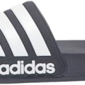 Pair of Adidas Adilette shower slides in black with white iconic three stripes.