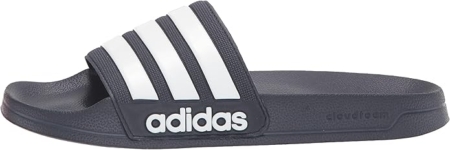Pair of Adidas Adilette shower slides in black with white iconic three stripes.